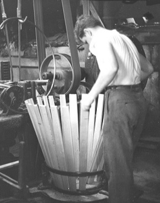 42-gallon oil barrel is assembled by a skilled cooper.