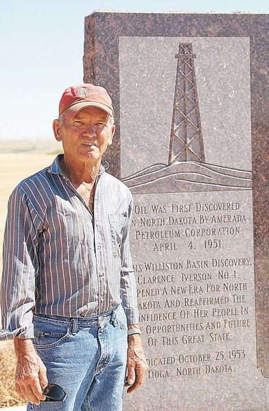 April-4-Williston-monument-AOGHS First North Dakota oil well where Cliff Iverson stands by his well's monument erected in 1953.