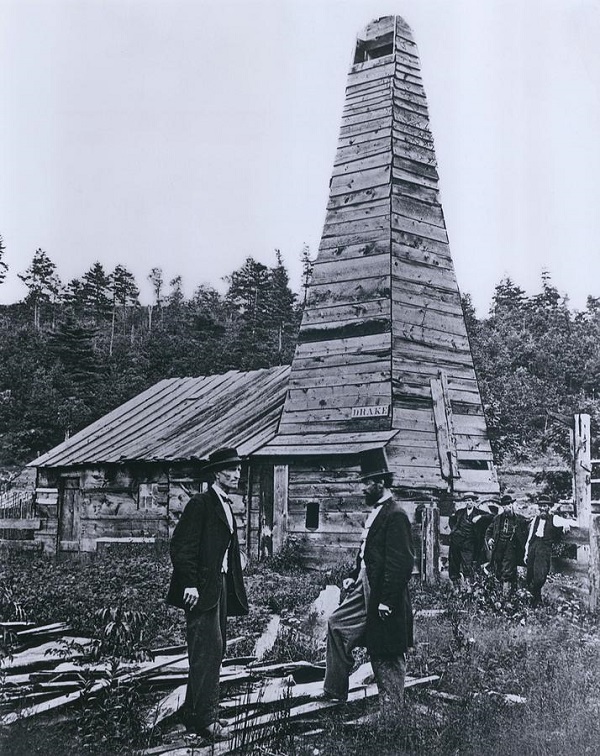 Edwin Drake stands with a friend in front of the famous wooden derrick at Oil Creek, PA, circa 1860.