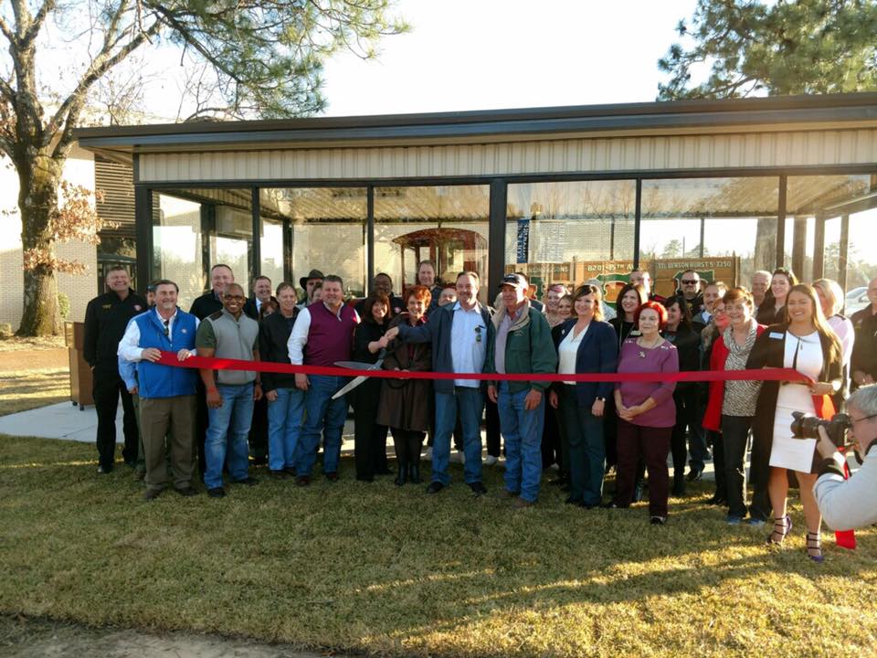 Staff and volunteers stand in front of the latest display addition to the East Texas Oil Museum in Kilgore, Texas.