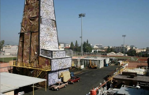 A modern camouflaged oil derrick in Los Angeles looks like a colorful tribute to modern art..