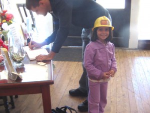A young visitor wears a plastic hard hat during her visit to the oil museum in Luling, TX.
