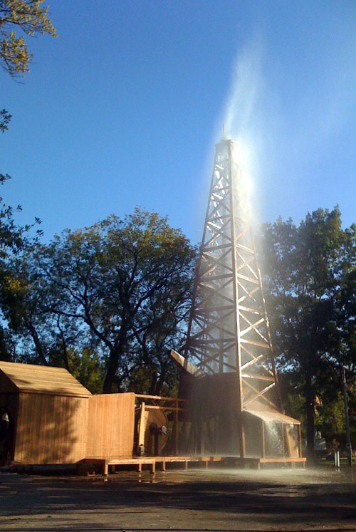Bartlesville-Gusher Modern re-enactment of oil gusher using water at wooden derrick.
