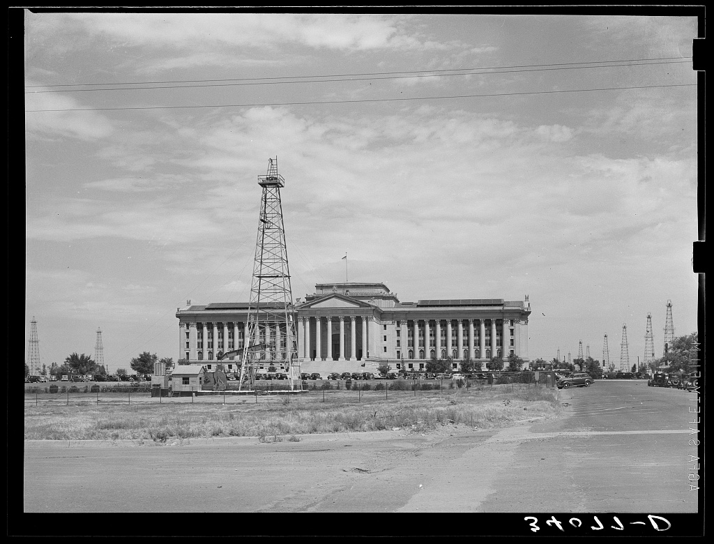 Capitol of Oklahoma with an oil derrick in front
