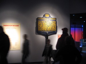 Visitors walk by the Smithsonian transportation hall's interstate marker exhibit.