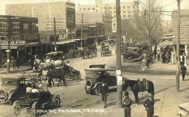 Historic circa 1920s photograph of cars and carriages with words "Main St Ranger, Texas.